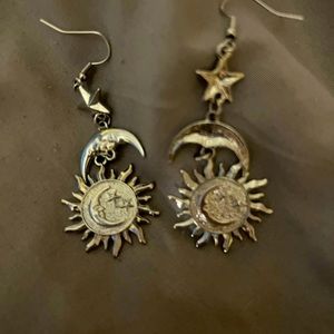 Silver Dangly Earrings with a star, moon, and sun. BRAND NEW